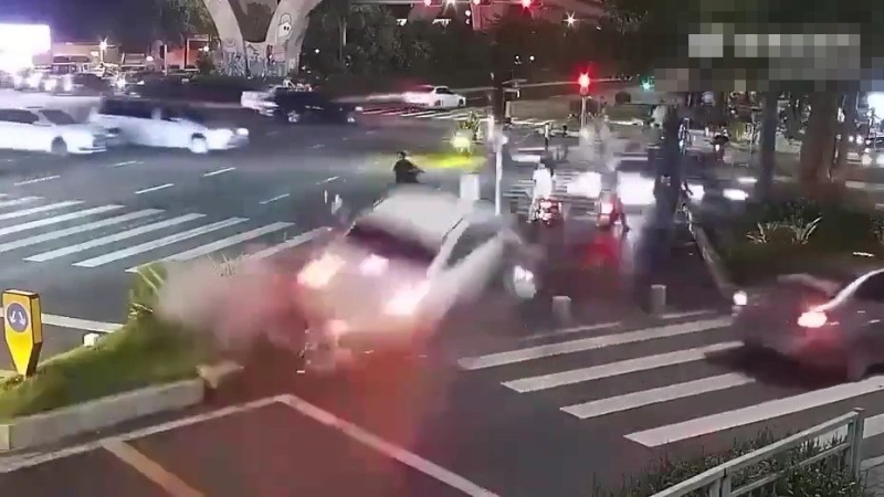 白色私家突然失控沖上行人路。