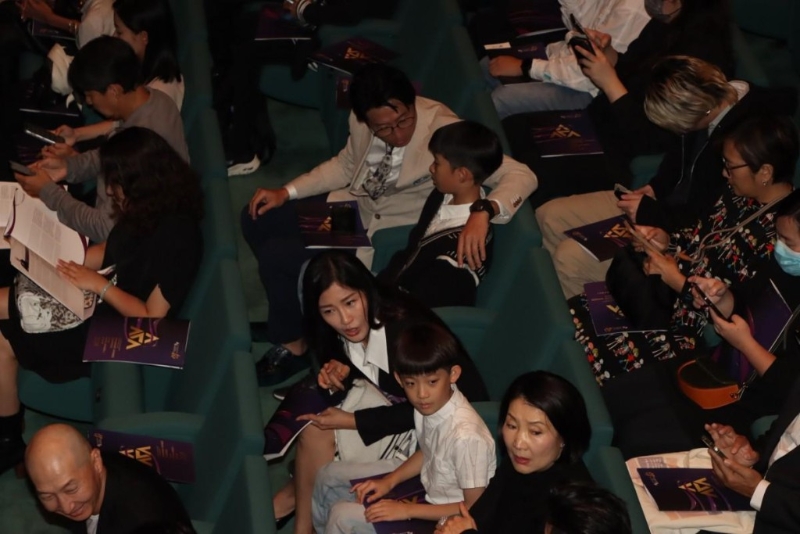 洪天明與太太周家蔚帶著兩名兒子到場支持爺爺洪金寶。圖中穿黑色上衣的高麗虹與洪天明兒子望同一方向，似乎在聊天，神情很可愛。